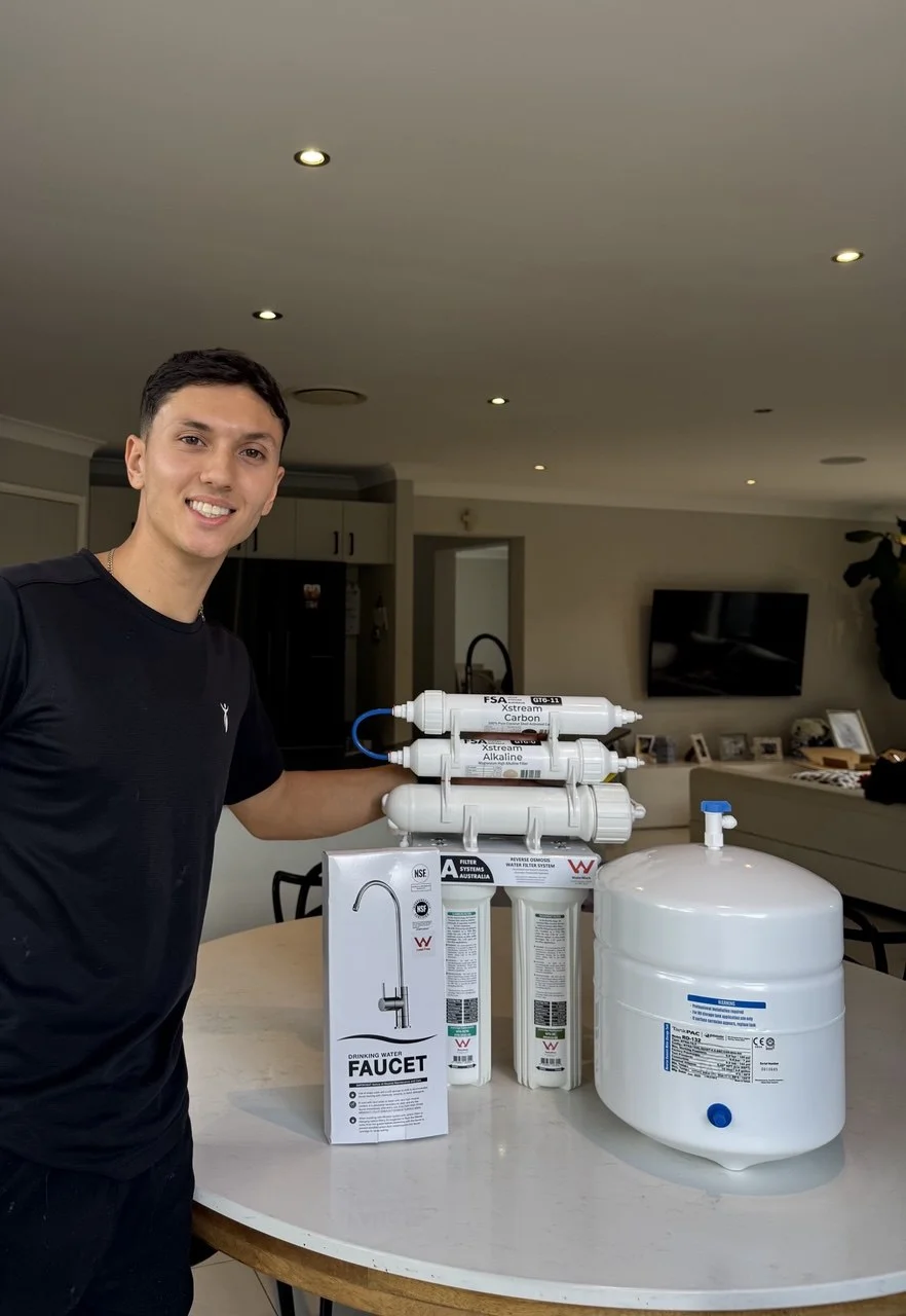 Reverse osmosis system being installed under Sydney kitchen sink
