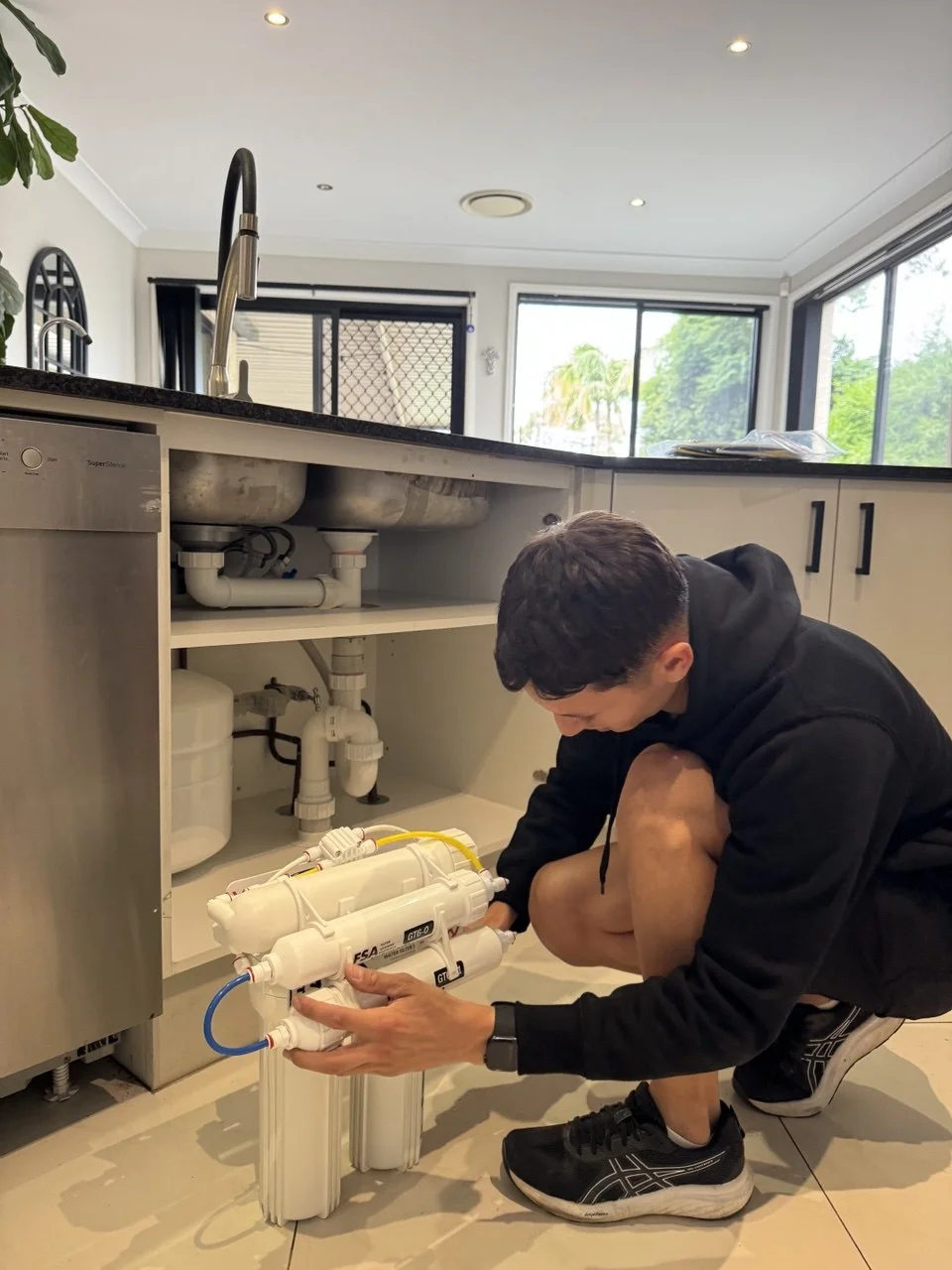 RO filter cartridges and tank installed under kitchen sink Sydney