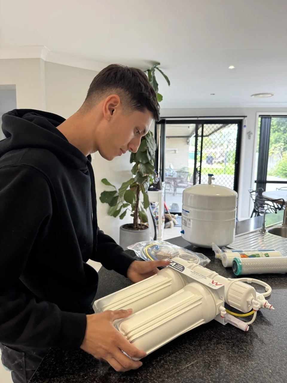 Jean-Paul connecting RO water lines under kitchen sink Sydney