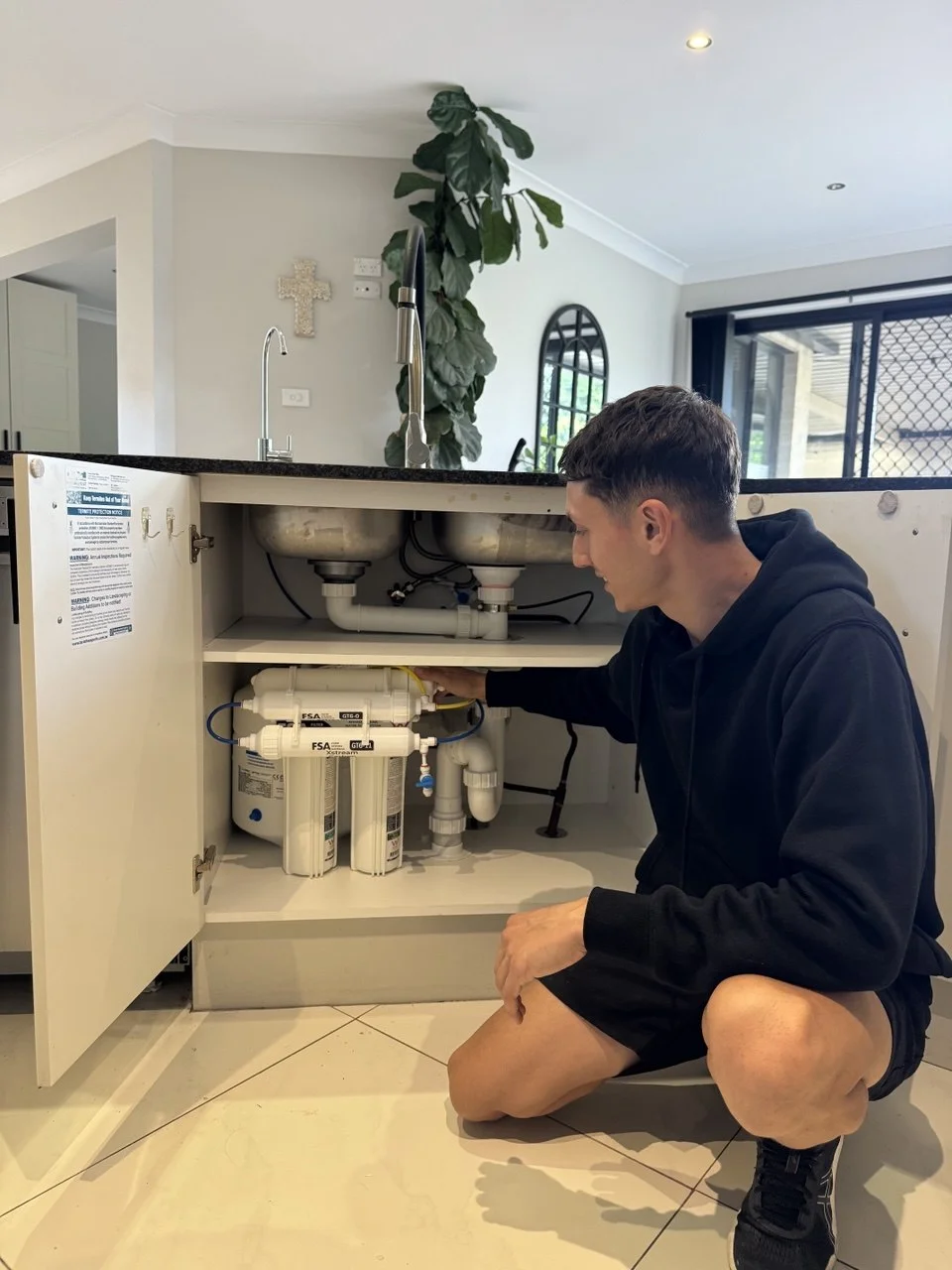 Licensed plumber completing RO filter installation Sydney