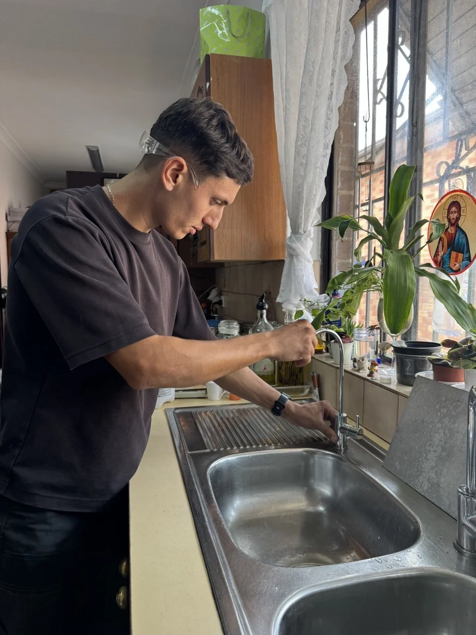 Jean-Paul Barbar installing an under-sink water filter at a Sydney kitchen