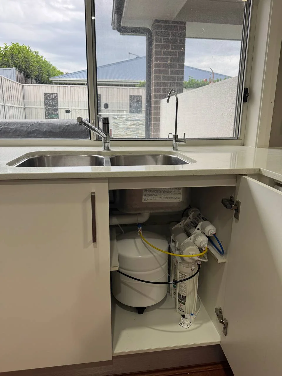Under sink water filter system installed under cabinet Sydney home