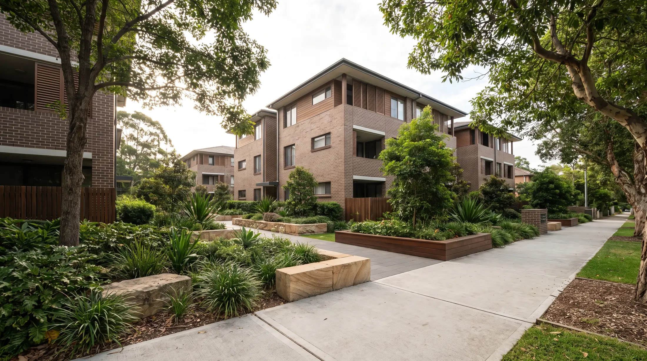 Contemporary residential buildings with landscaped entrances on a Beaconsfield street, illustrative residential scene