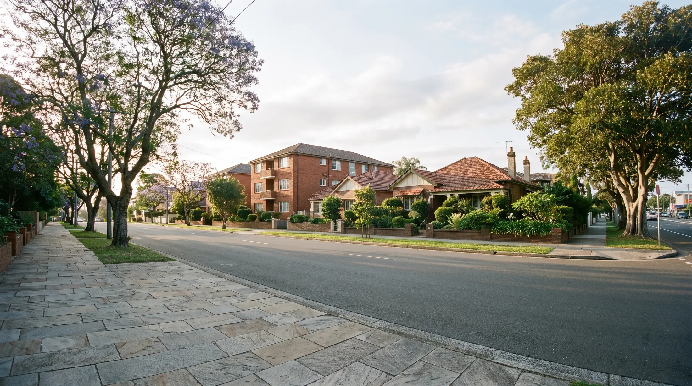 Apartment buildings and established homes along a Kingsford residential street, illustrative residential scene