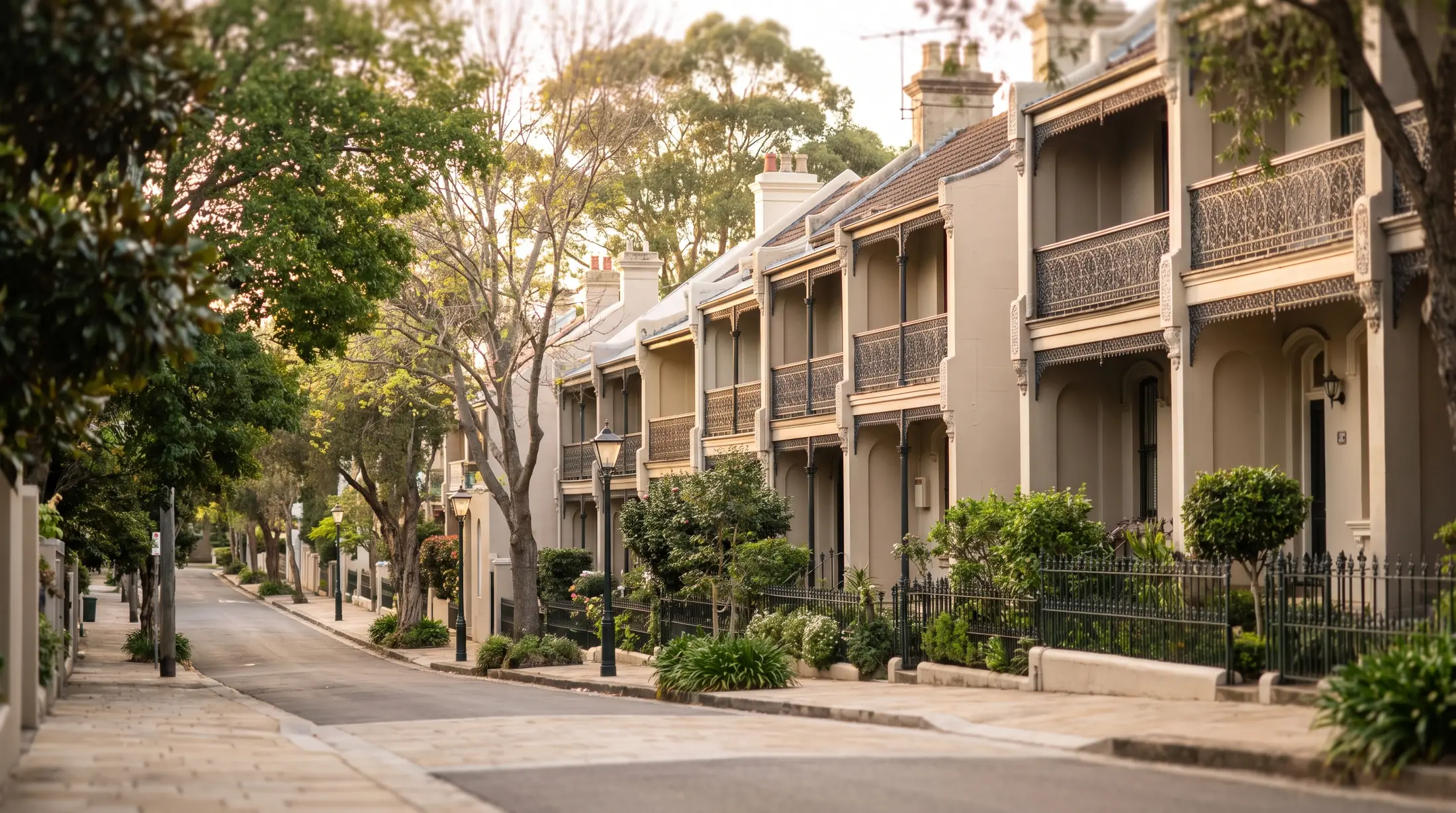 Painted Victorian terrace homes along a sloping Paddington street, illustrative residential scene