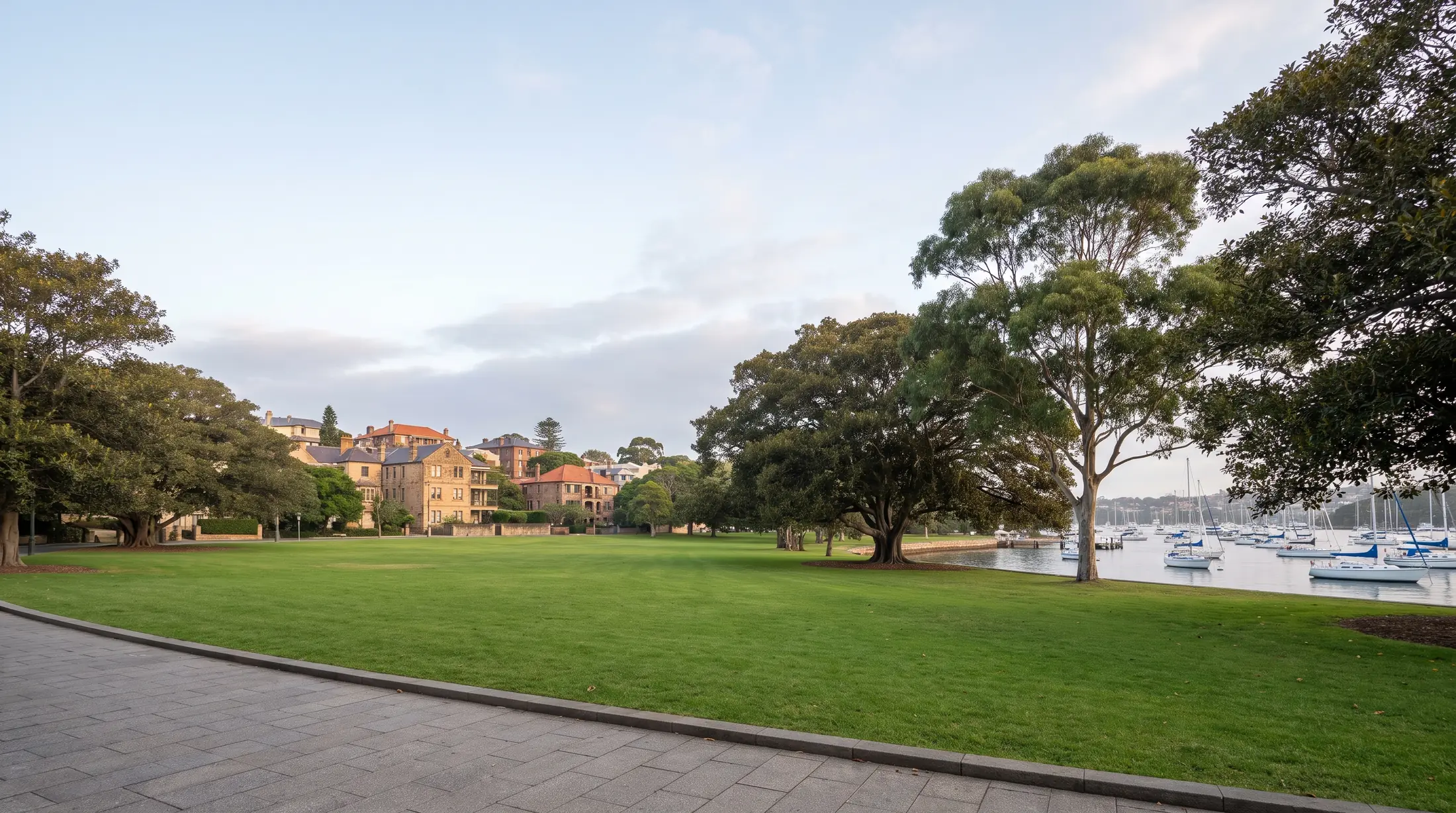 Harbour water, mature trees and a walking path beside Rushcutters Bay park, illustrative residential scene