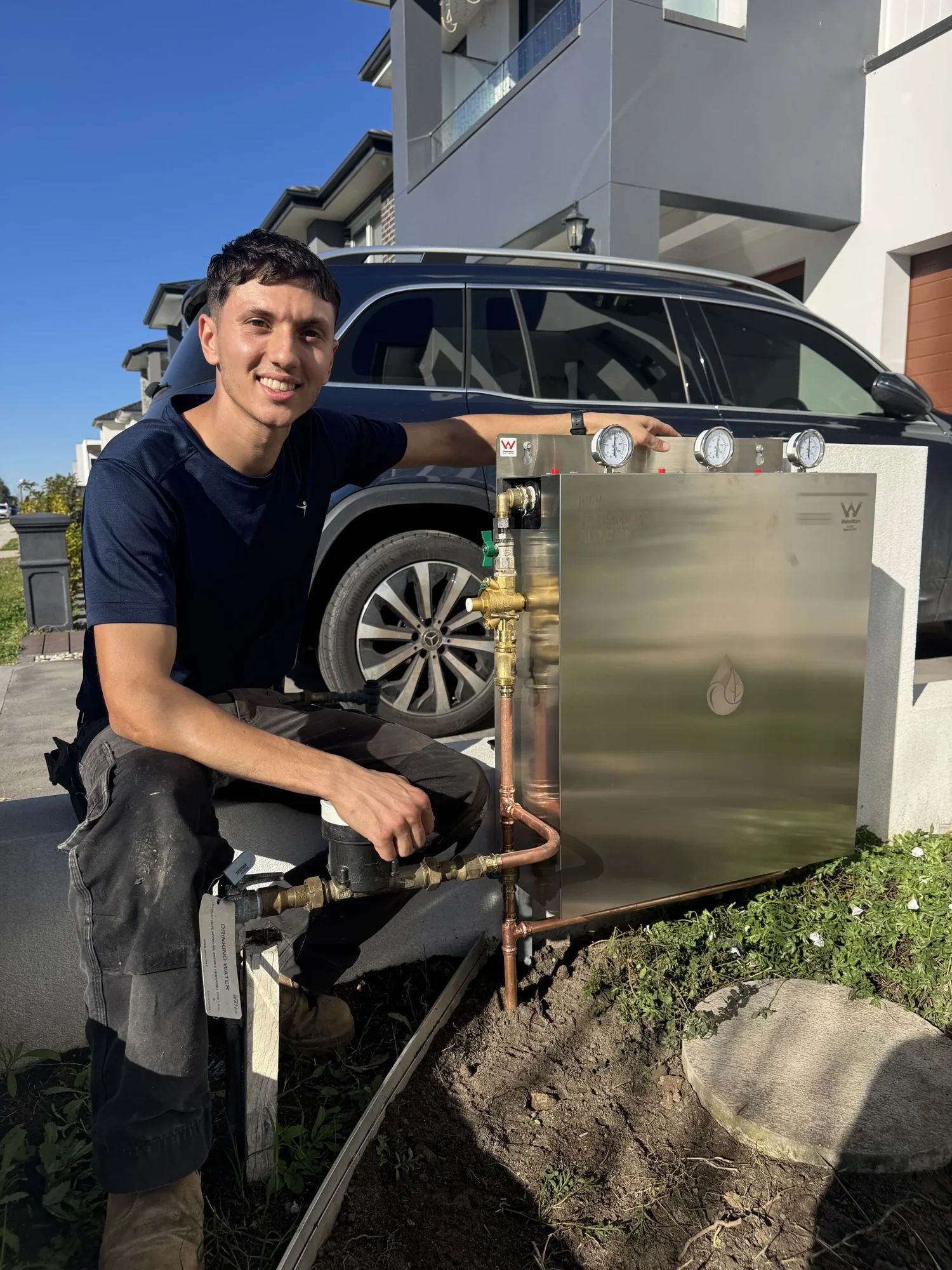 Our installer fitting a whole house filtration system at a new Sydney development