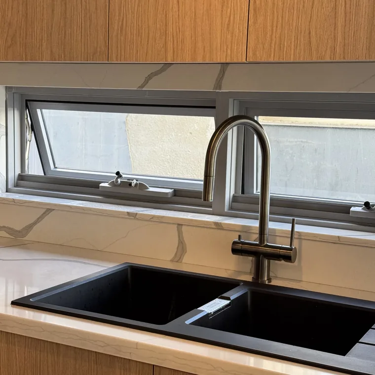 A 3 way mixer tap in chrome at a Sydney kitchen sink