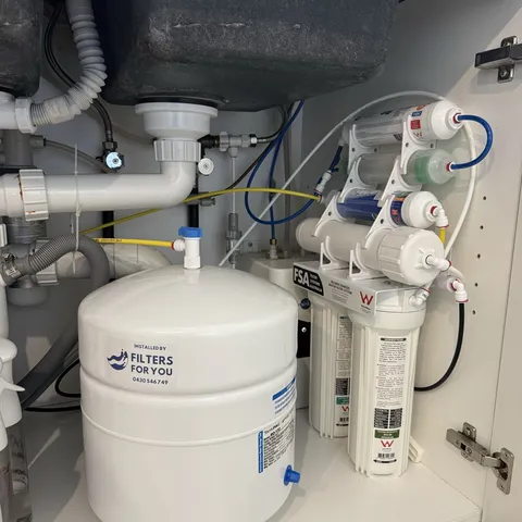 A multi stage reverse osmosis system installed in a cabinet with its tank