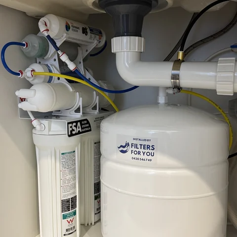 A finished under sink reverse osmosis install with branded cartridges