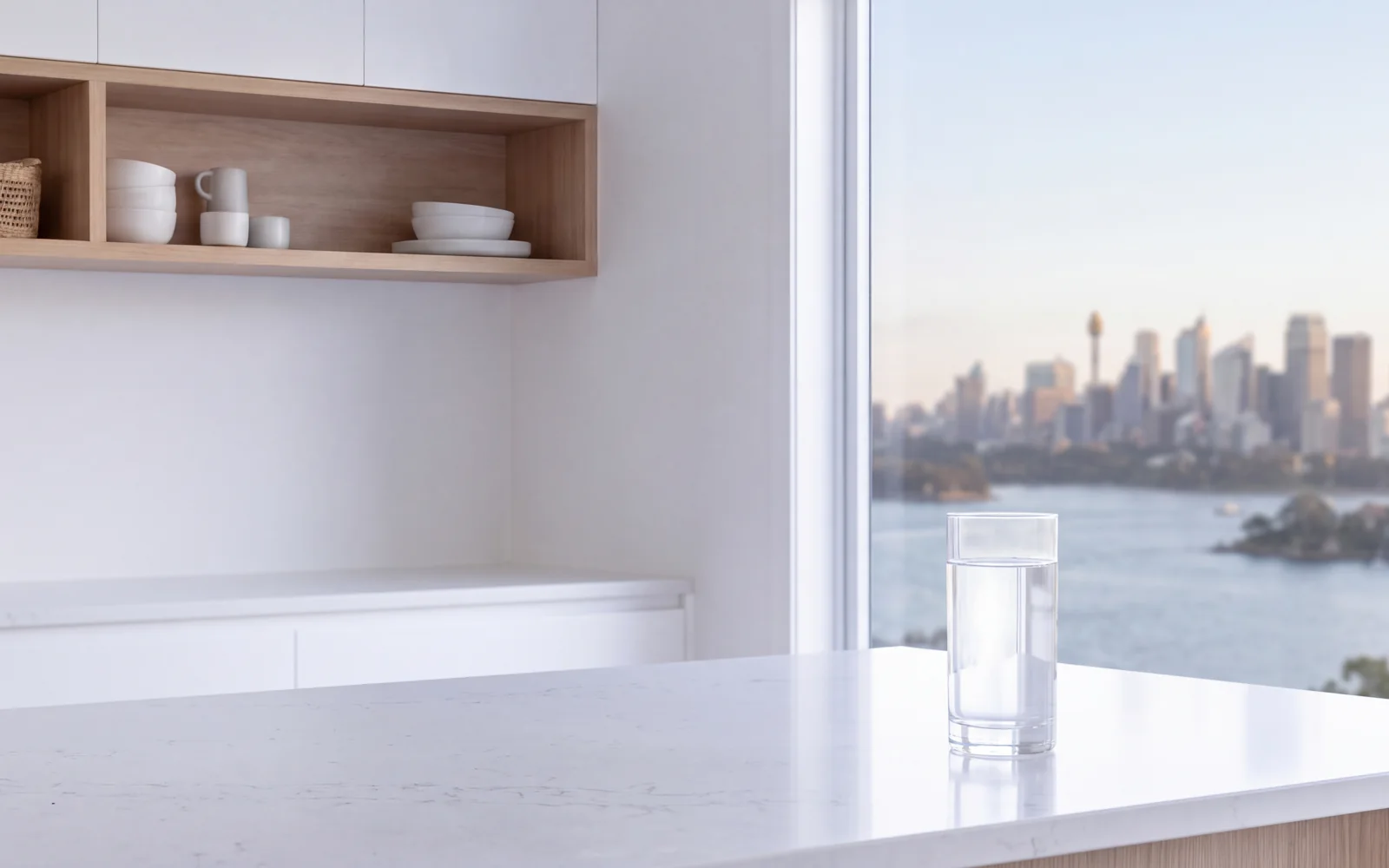 A glass of purified water at the window, the Sydney skyline beyond